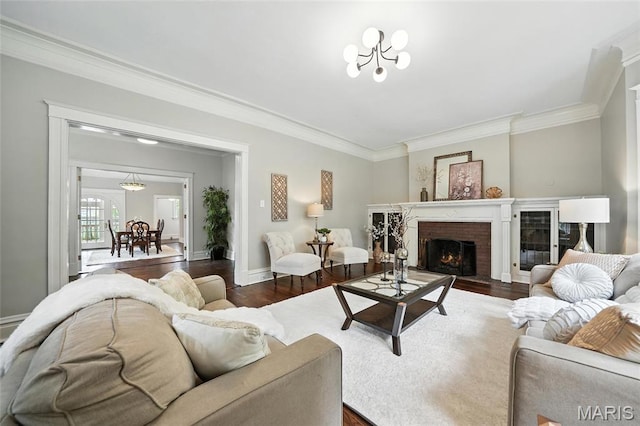 6336 Pershing Ave, University City, MO 63130 - living room with dark wood-style floors, crown molding, and a brick fireplace