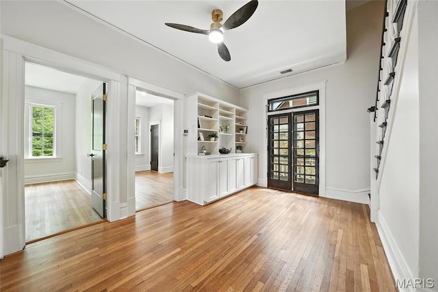 6336 Pershing Ave, University City, MO 63130 - empty room with light wood-style flooring, ceiling fan, and french doors
