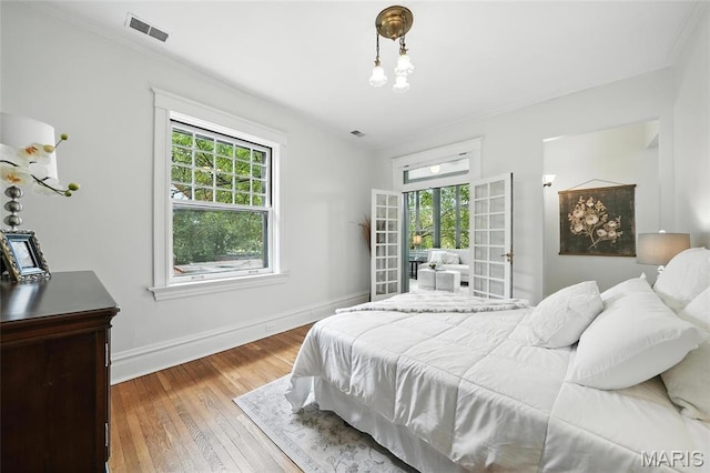 6336 Pershing Ave, University City, MO 63130 - bedroom with hardwood / wood-style flooring, french doors, and ornamental molding