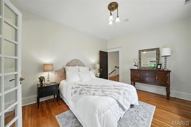 6336 Pershing Ave, University City, MO 63130 - bedroom with baseboards and wood finished floors