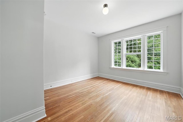 6336 Pershing Ave, University City, MO 63130 - spare room featuring light wood-style flooring and baseboards