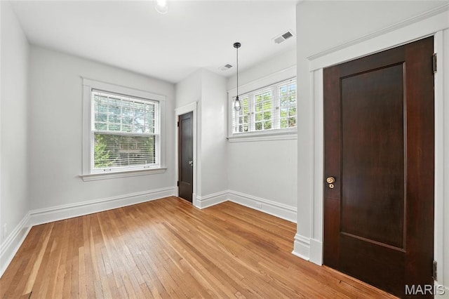 6336 Pershing Ave, University City, MO 63130 - unfurnished room with light wood-style floors and baseboards