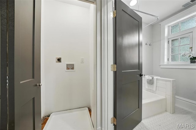 6336 Pershing Ave, University City, MO 63130 - bathroom featuring a tub and baseboards