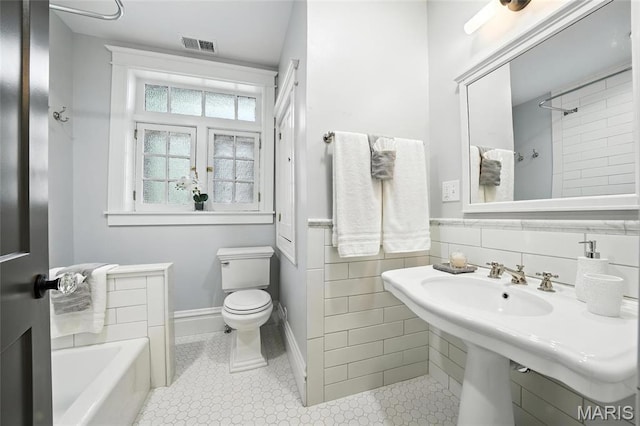 6336 Pershing Ave, University City, MO 63130 - bathroom featuring a tub, tile patterned flooring, and a shower