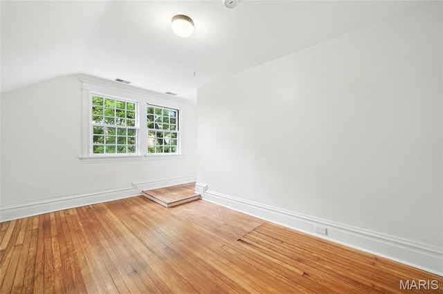 6336 Pershing Ave, University City, MO 63130 - empty room with vaulted ceiling and light wood-type flooring