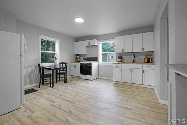 2162 State St, Granite City, IL 62040 - kitchen with white appliances, light wood-style flooring, and white cabinets