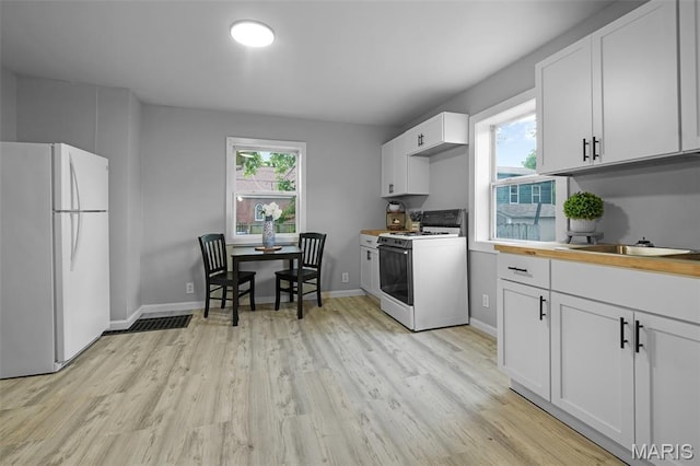 2162 State St, Granite City, IL 62040 - kitchen featuring white appliances, light wood-style floors, white cabinetry, and light countertops