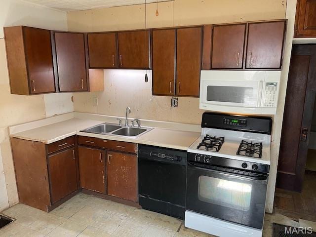 8614 Hume Ave, St John, MO 63114 - kitchen featuring dishwasher, white microwave, gas stove, and light countertops