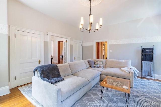 4365 Forest Park Ave, Saint Louis, MO 63108 - living room featuring a chandelier and light wood-style flooring