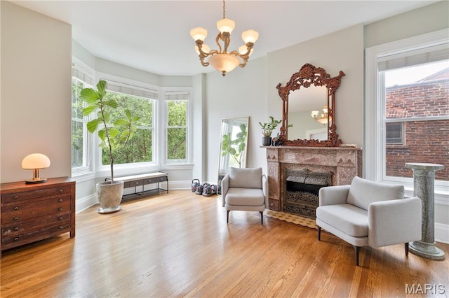 4365 Forest Park Ave, Saint Louis, MO 63108 - sitting room with wood finished floors, a chandelier, and a premium fireplace