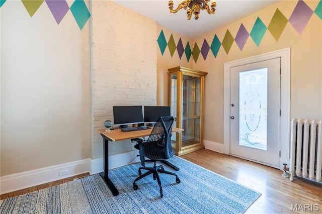 4365 Forest Park Ave, Saint Louis, MO 63108 - office featuring radiator heating unit, a chandelier, and wood finished floors