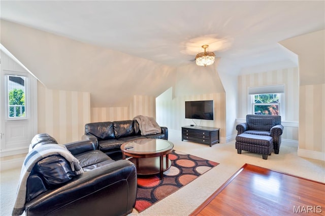 4365 Forest Park Ave, Saint Louis, MO 63108 - living area with wallpapered walls, wood finished floors, carpet floors, and lofted ceiling