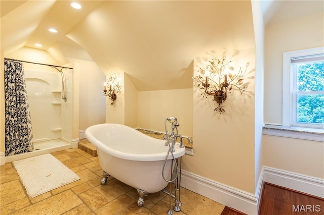 4365 Forest Park Ave, Saint Louis, MO 63108 - full bathroom featuring vaulted ceiling, recessed lighting, a freestanding bath, a shower, and stone tile flooring