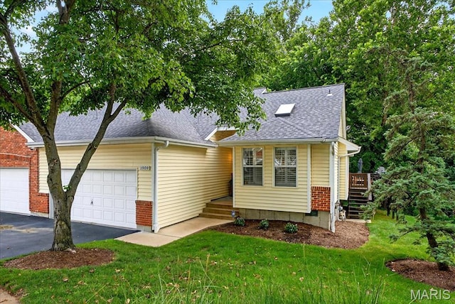 1909 King Arthur Ct, Saint Louis, MO 63146 - view of front facade with asphalt driveway, a shingled roof, a front lawn, and a garage