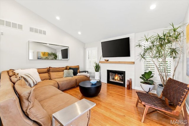 1909 King Arthur Ct, Saint Louis, MO 63146 - living area with light wood-style floors, lofted ceiling, recessed lighting, and a tile fireplace