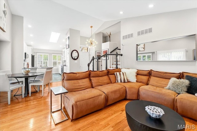 1909 King Arthur Ct, Saint Louis, MO 63146 - living area featuring a skylight, light wood finished floors, high vaulted ceiling, a chandelier, and recessed lighting