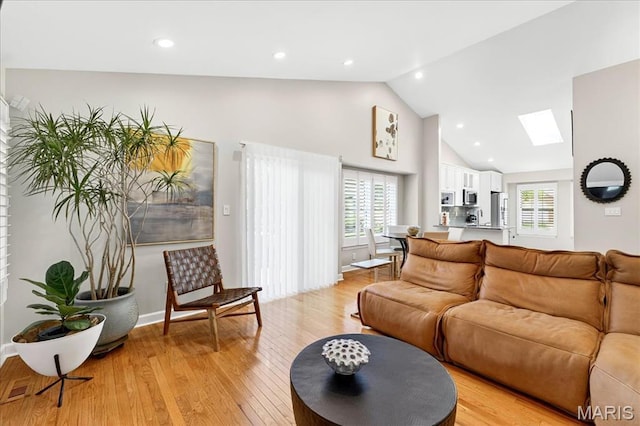 1909 King Arthur Ct, Saint Louis, MO 63146 - living area featuring a skylight, light wood-style flooring, high vaulted ceiling, healthy amount of natural light, and recessed lighting