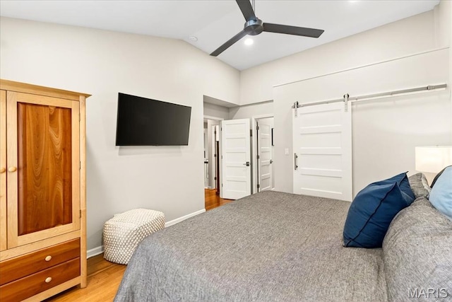 1909 King Arthur Ct, Saint Louis, MO 63146 - bedroom featuring vaulted ceiling, a barn door, wood finished floors, and a ceiling fan