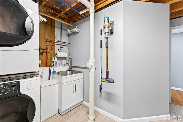 1909 King Arthur Ct, Saint Louis, MO 63146 - laundry area featuring stacked washer / dryer and light wood-style floors
