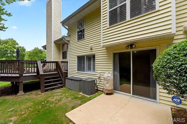 1909 King Arthur Ct, Saint Louis, MO 63146 - rear view of property featuring a chimney, a deck, and a patio