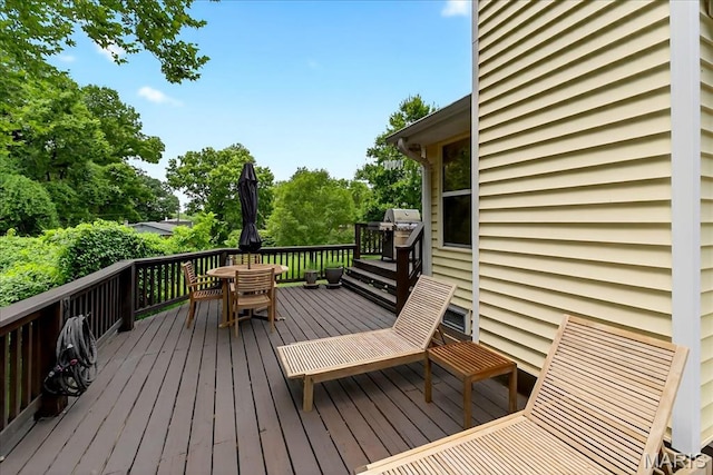 1909 King Arthur Ct, Saint Louis, MO 63146 - wooden terrace with outdoor dining space, grilling area, and view of wooded area