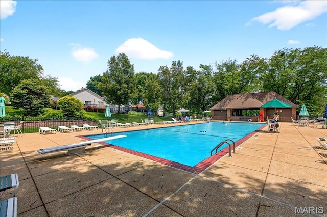1909 King Arthur Ct, Saint Louis, MO 63146 - community pool featuring a patio, a diving board, and view of scattered trees