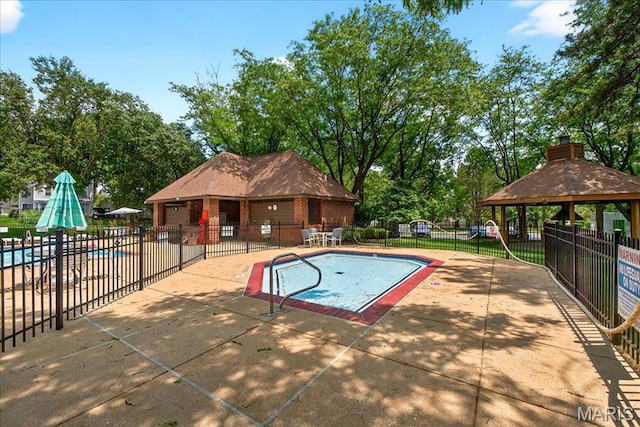 1909 King Arthur Ct, Saint Louis, MO 63146 - community pool featuring a gazebo, a patio area, and view of wooded area