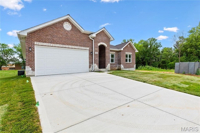 522 Dove Dr, Saint Charles, MO 63301 - view of front of house featuring a garage, brick siding, concrete driveway, and a front yard
