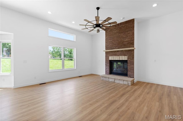 522 Dove Dr, Saint Charles, MO 63301 - unfurnished living room with ceiling fan, light wood-style flooring, recessed lighting, and a fireplace