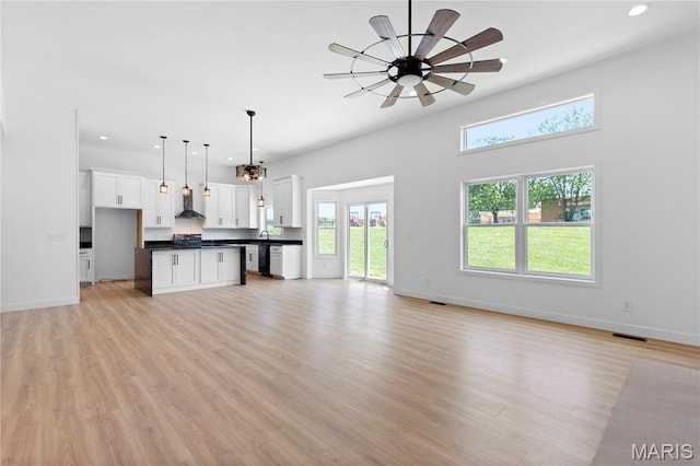 522 Dove Dr, Saint Charles, MO 63301 - unfurnished living room featuring plenty of natural light, ceiling fan, recessed lighting, and light wood finished floors