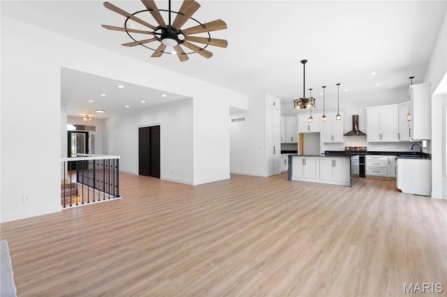 522 Dove Dr, Saint Charles, MO 63301 - unfurnished living room featuring a ceiling fan, light wood-type flooring, and recessed lighting