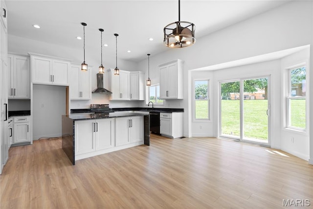 522 Dove Dr, Saint Charles, MO 63301 - kitchen featuring dishwasher, dark countertops, range with electric stovetop, light wood finished floors, and recessed lighting