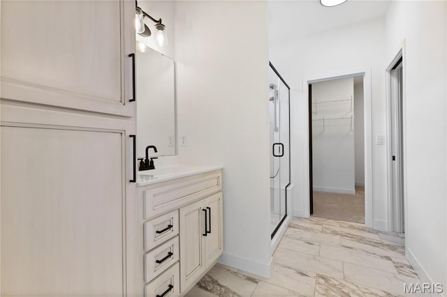 522 Dove Dr, Saint Charles, MO 63301 - bathroom featuring a stall shower, vanity, a spacious closet, and marble finish flooring
