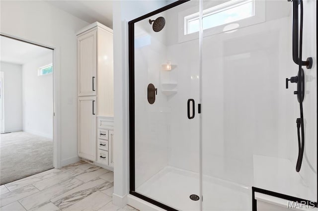 522 Dove Dr, Saint Charles, MO 63301 - bathroom featuring a shower stall and marble look tiles