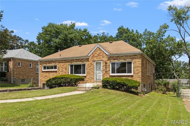 7637 Lynn Ave, University City, MO 63130 - view of front of home featuring a front yard, brick siding, and a shingled roof