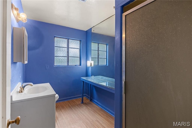7637 Lynn Ave, University City, MO 63130 - bathroom featuring vanity and wood finished floors