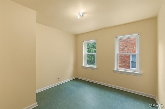 7637 Lynn Ave, University City, MO 63130 - spare room featuring baseboards and dark floors