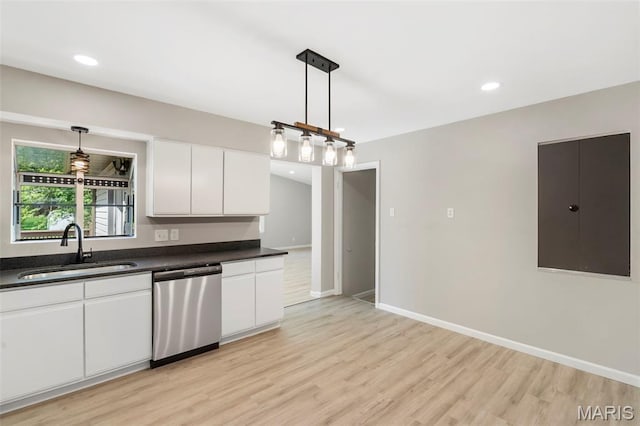 490 Lula Dr, Florissant, MO 63031 - kitchen with dishwasher, dark countertops, light wood finished floors, white cabinets, and pendant lighting