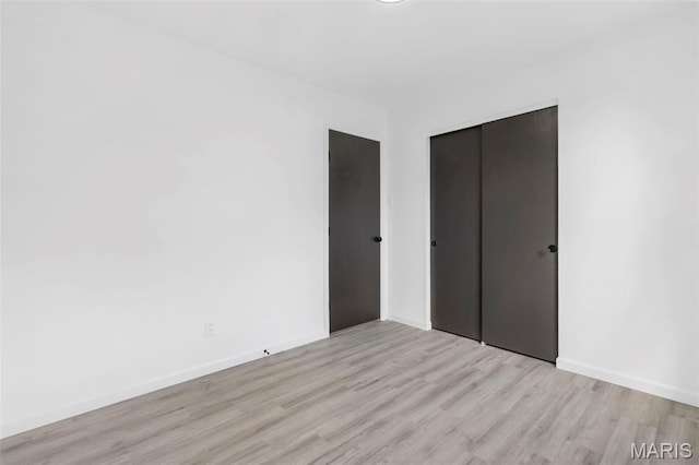 490 Lula Dr, Florissant, MO 63031 - unfurnished bedroom with wood finished floors and a closet