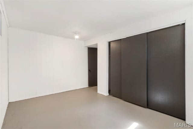 490 Lula Dr, Florissant, MO 63031 - unfurnished bedroom featuring concrete flooring, elevator, and a closet