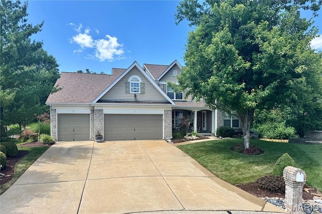 616 Remmick Stables Ct, Ofallon, MO 63368 - traditional-style home with a front yard, driveway, a garage, and brick siding