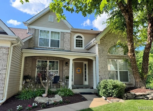 616 Remmick Stables Ct, Ofallon, MO 63368 - traditional home with covered porch and brick siding