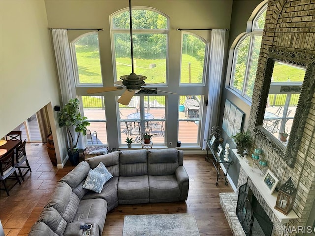 616 Remmick Stables Ct, Ofallon, MO 63368 - living room featuring ceiling fan, plenty of natural light, a fireplace, and a high ceiling