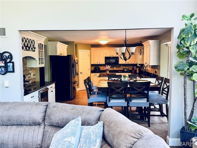 616 Remmick Stables Ct, Ofallon, MO 63368 - kitchen with black appliances, open floor plan, dark countertops, and beverage cooler