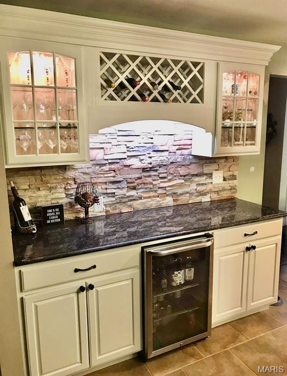 616 Remmick Stables Ct, Ofallon, MO 63368 - indoor dry bar with beverage cooler, light tile patterned flooring, and backsplash