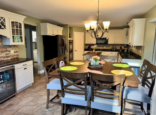 616 Remmick Stables Ct, Ofallon, MO 63368 - dining space with a chandelier and wine cooler