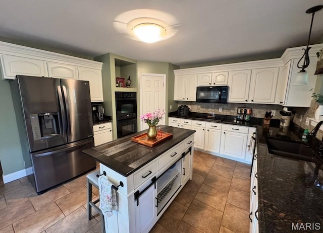 616 Remmick Stables Ct, Ofallon, MO 63368 - kitchen featuring black appliances, tasteful backsplash, white cabinetry, and hanging light fixtures