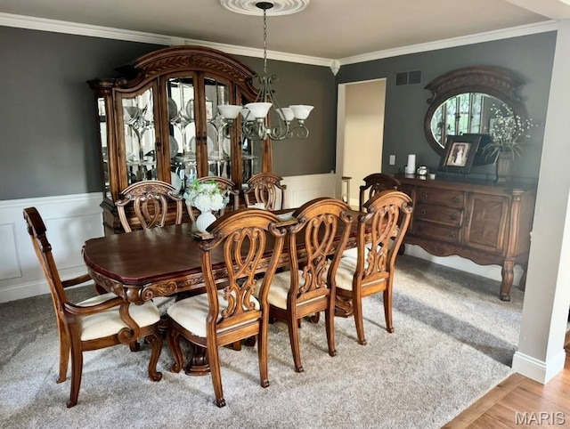 616 Remmick Stables Ct, Ofallon, MO 63368 - dining room with a chandelier, ornamental molding, a wainscoted wall, and light wood finished floors