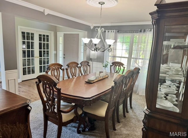 616 Remmick Stables Ct, Ofallon, MO 63368 - dining space with ornamental molding, french doors, a chandelier, wainscoting, and light wood finished floors