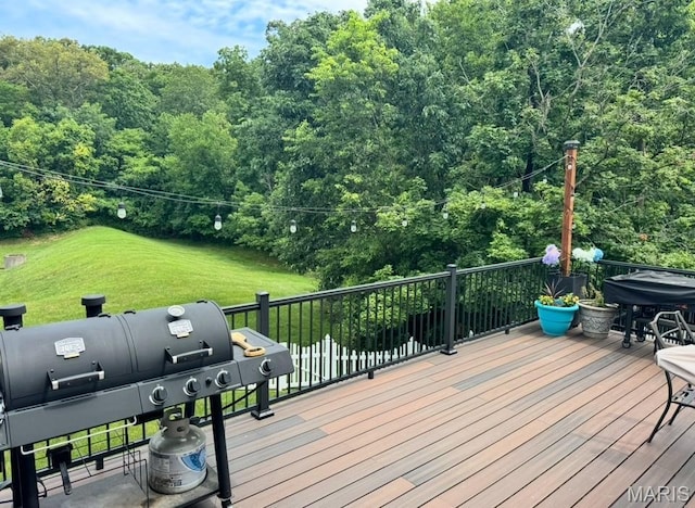 616 Remmick Stables Ct, Ofallon, MO 63368 - deck with area for grilling, a forest view, and a lawn